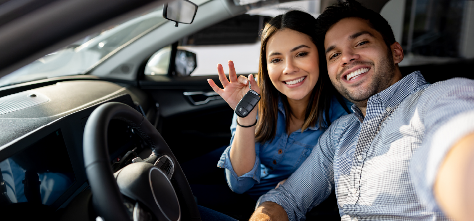 IMAGE: Couple smiling in car with woman holding keys