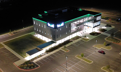 IMAGE: Texell headquarters at night with green lights along the roof line