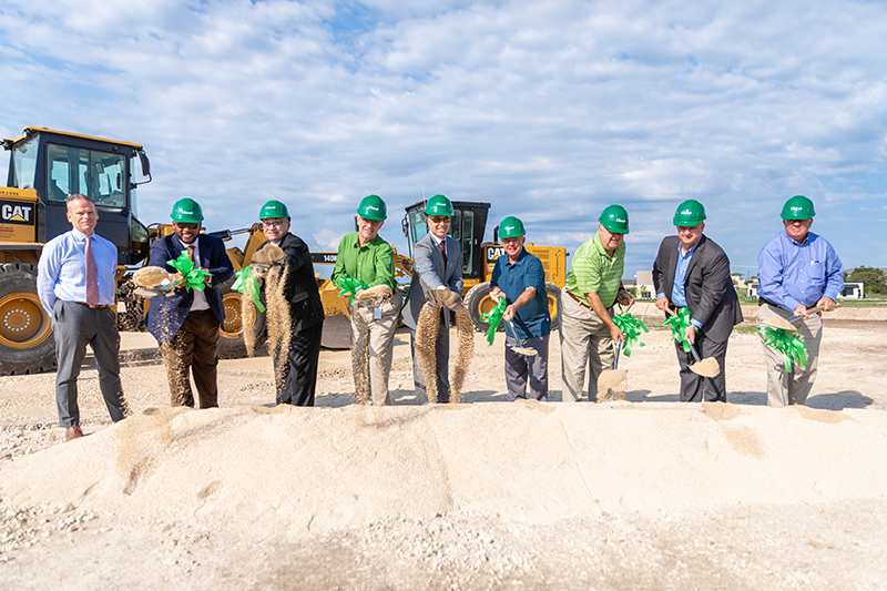 IMAGE: Dignitaries with hard hats on and shovel in hand at HQ groundbreaking ceremony