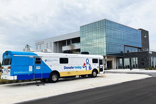 IMAGE: Baylor Scott & White bus for mobile blood drives in front of Texell's headquarters