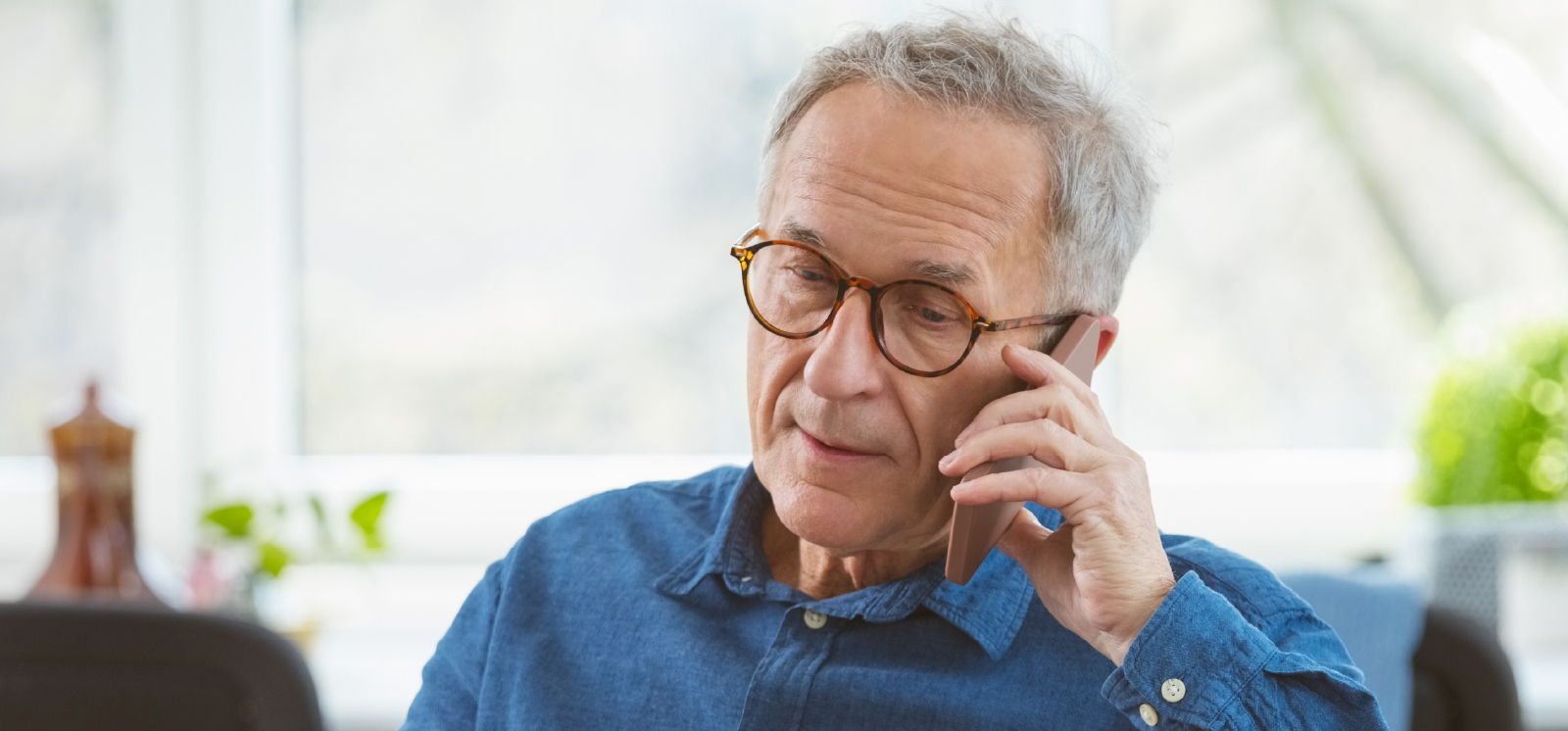 IMAGE: Man talking on phone inside home
