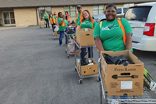 IMAGE: Texell employees with carts of donated food to load into vehicles at Brighter Days Food Pantry