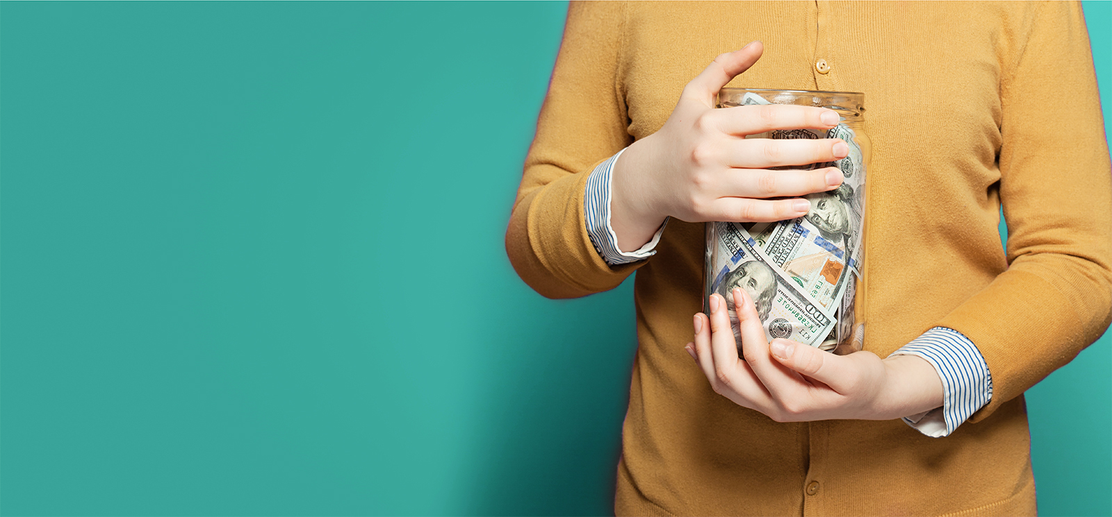IMAGE: Person holding jar full of money