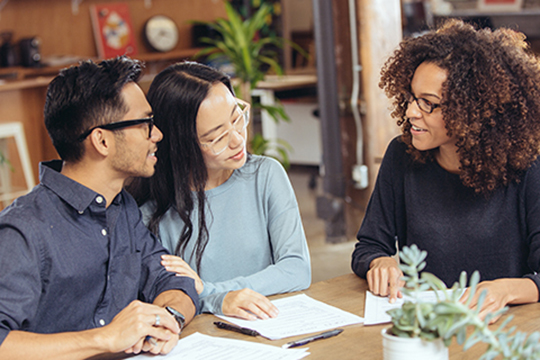 IMAGE: Couple talking with tax advisor