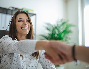 IMAGE: Woman smiling and shaking hands