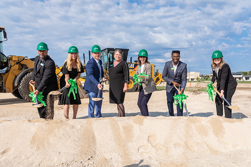 IMAGE: Managers with hard hats and shovel in hand at HQ groundbreaking ceremony