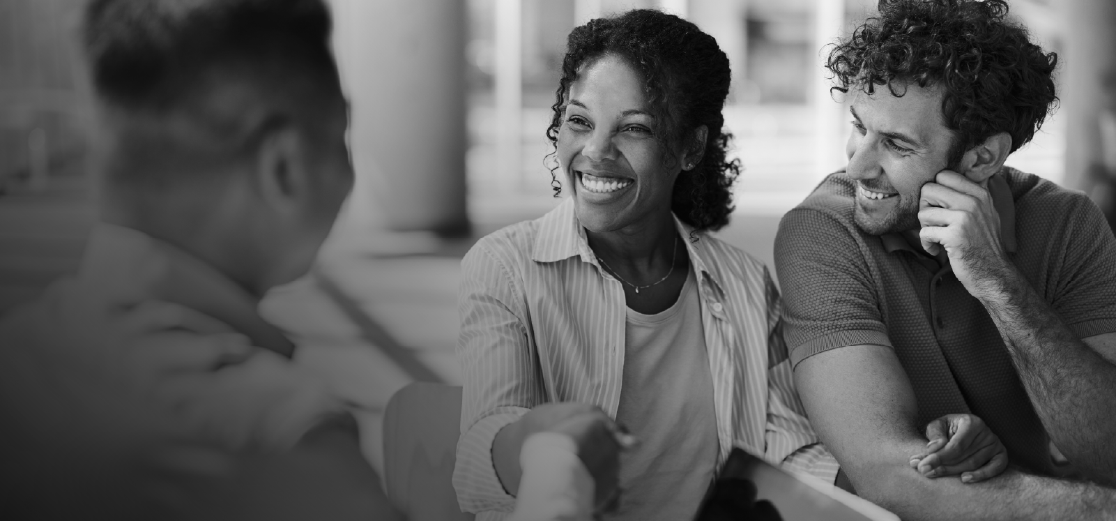 IMAGE: Couple smiling and shaking hand of a representative