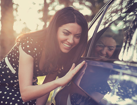 IMAGE: Girl admiring car and running hand alongside it