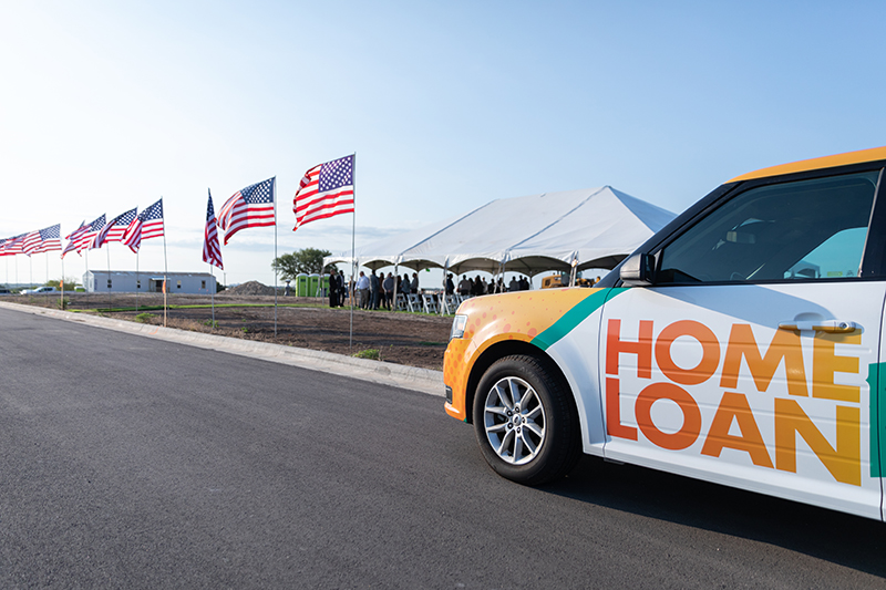 IMAGE: Texell Home Loans vehicle with flags lined up and tent in background at HQ groundbreaking ceremony
