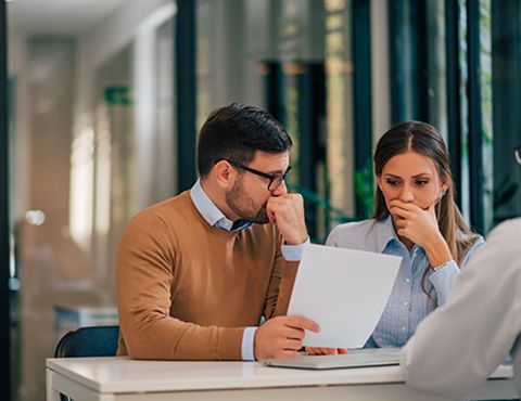 IMAGE: Worried couple looking at document