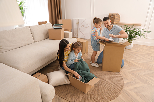 IMAGE: Family unpacking boxes inside new home