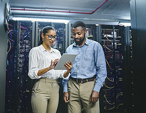 IMAGE: Employees working in a server room